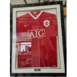 A framed and glazed MUFC shirt, signed "Barclays Premier Champions 2006-7"; a framed darts poster.