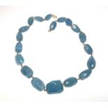 AQUAMARINE, a necklace of graduated faceted beads, approx 370 carat, on yellow metal wire mounts and