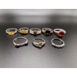 8 silver rings stamped '925' with assorted coloured stones in a variety of settings total weight