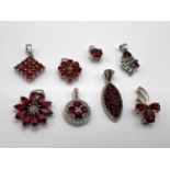 8 silver pendants set with a variety of red coloured stones