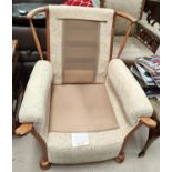 An Ercol style armchair with light wood frame