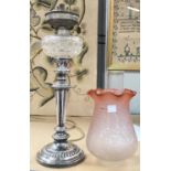 A 19th century silver plated oil lamp with cut glass reservoir and pink glass shade