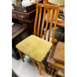 A set of four teak rail back dining chairs