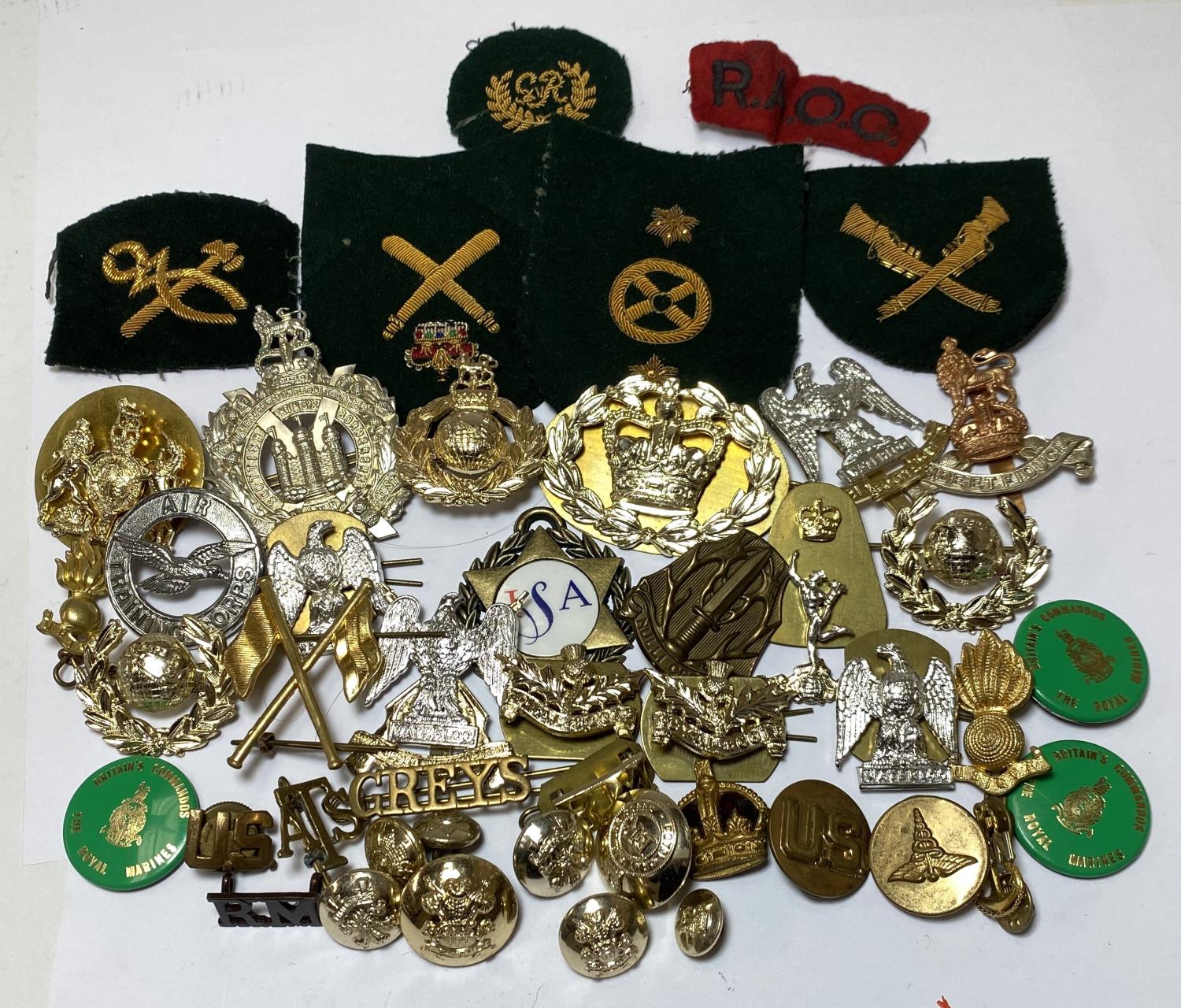 A selection of modern military cap and other badges