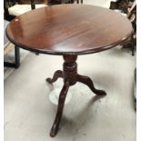 An early 19th century mahogany occasional table with circular tilt top