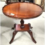 A reproduction mahogany wine table on 4 feet; a reproduction mahogany wine table on tripod base