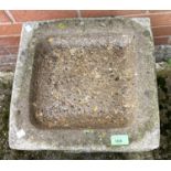 A reconstituted stone bird bath