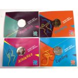 Four 2012 Olympic 50p coins in Royal Mint packs: aquatics, archery, athletics and cycling.