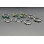 5 silver rings stamped '925' with emerald coloured stones in a variety of settings; 2 further silver