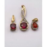 3 9ct gold pendants, each set with central red/pink stone and clear stones in mounts, 3.8gm gross
