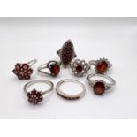 A selection of silver rings set with a variety of red coloured stones
