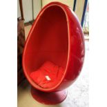 A 1960's Thor Larsen style egg chair in red with red interior