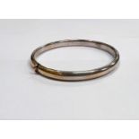 A white metal hinged bangle stamped 14k Italy, 8.7gms