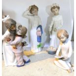 Three Nao figures of children in night clothes 1 a.f and a Nao group of girls exchanging gifts