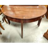 A Georgian mahogany circular dining table formed from 2 demi-lune ends, 1 spare leaf, extended