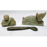 A Chinese jade coloured carving of a figure with a toad; two similar items.