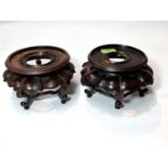 A matched pair of Chinese carved hard wood vase stands with naturalistic decoration, height diameter