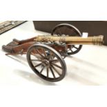 A reproduction miniature French cannon, with name tag Louis XIV, length 44cm