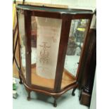 A 1950's walnut display cabinet with bow front