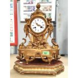 A 19th century French mantel clock in ormolu case with acanthus pediment and female bust side