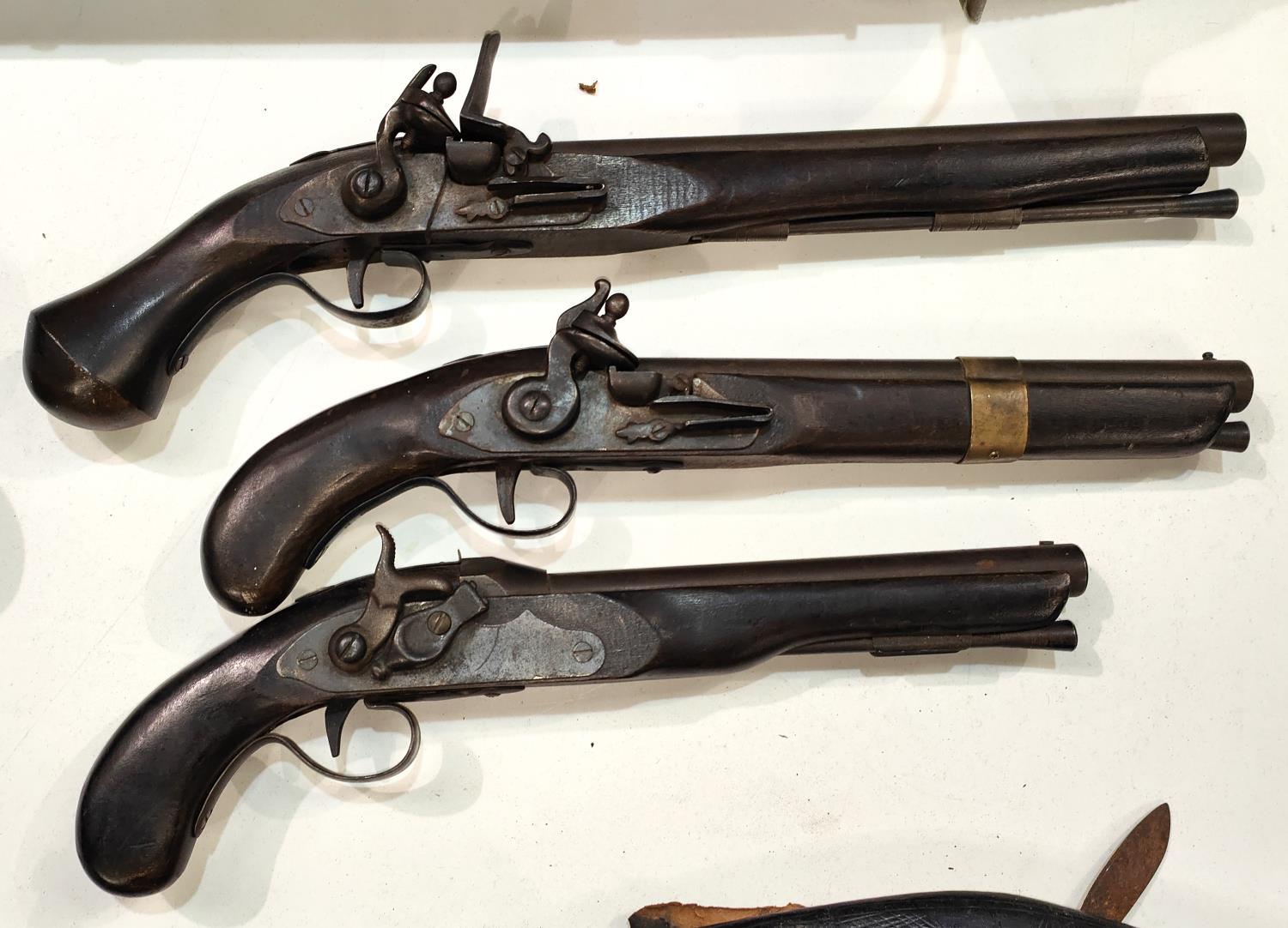 Three replica pistols:  a percussion cap and 2 flintlocks