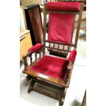 A 19th century American rocking armchair in wine dralon