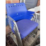 A set of 4 chrome framed moulded blue plastic stacking chairs