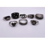 8 silver rings all set with black pave set stone chips, testing as black diamonds, some with similar