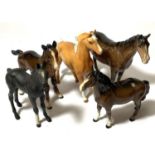 Two small Beswick horse figures and two Beswick style colt and a Royal Doulton black colt.