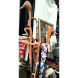 A painted Sheppard's crook and a selection of other walking sticks