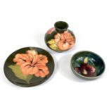 A Moorcroft green ground Orchid design pin dish, 8cm; a similar vase with peach colour Hibiscus