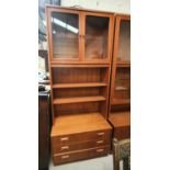 A Gplan teak wall unit with glazed top cupboard over 2 shelves with 3 drawers below
