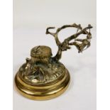 A Victorian brass desk ink well in the form of tree stump with boy swinging from the branches