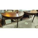 A Georgian mahogany circular dining table formed from 2 demi-lune ends, 1 spare leaf, extended