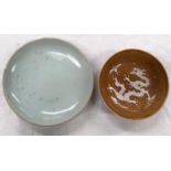 A 19th century oriental pale green glazed dish and a Chinese round glazed dish with relief dragon to