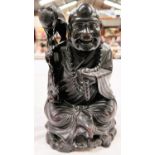 A Chinese hardwood carved depiction of seated Buddha with scholars brush height 27cm