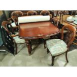 A Victorian style mahogany dining suite comprising rounded rectangular extending table (with one
