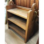 An oak Arts and Crafts style shoe rack with brass shoe horn