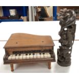 A unusual hardwood carved totem of dolphins and fishes swimming around a reef, and a small musical