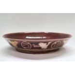 A Chinese plum coloured dish with incised yellow decoration to the outside of dish with birds etc,