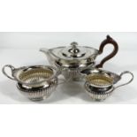 A 3 piece hallmarked silver tea set in the Georgian style with gadrooned and floral borders and