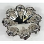 A hallmarked silver shallow pedestal dish of circular scalloped form with extensive pierced and