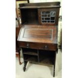 A Liberty's small oak bureau with open shelves and mullion glazed cupboard, folding side shelf,