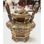 A Chinese brass censor with squat body 4 feet and raised handles relief decoration of mythical