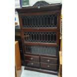 An Edwardian mahogany sectional bookcase with 3 leaded glass doors and 4 drawers