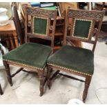 A set of 4 Edwardian carved oak dining chairs with green dralon seats