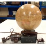A terrestrial globe; a Voigtlander 35mm camera; a vintage folding camera; a QEII Coronation tin