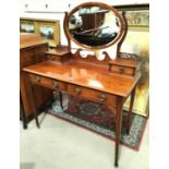 An Arts & Crafts period kneehole dressing table with 2 drawers and 2 jewellery drawers by Heals