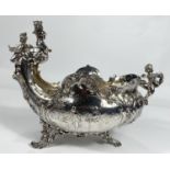 A 19th century French rococo vase, boat shaped with cherub mounts to the prow and stern and