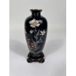 A Chinese cloisonne with deep blue ground floral decoration silvered rim vase attached to hardwood